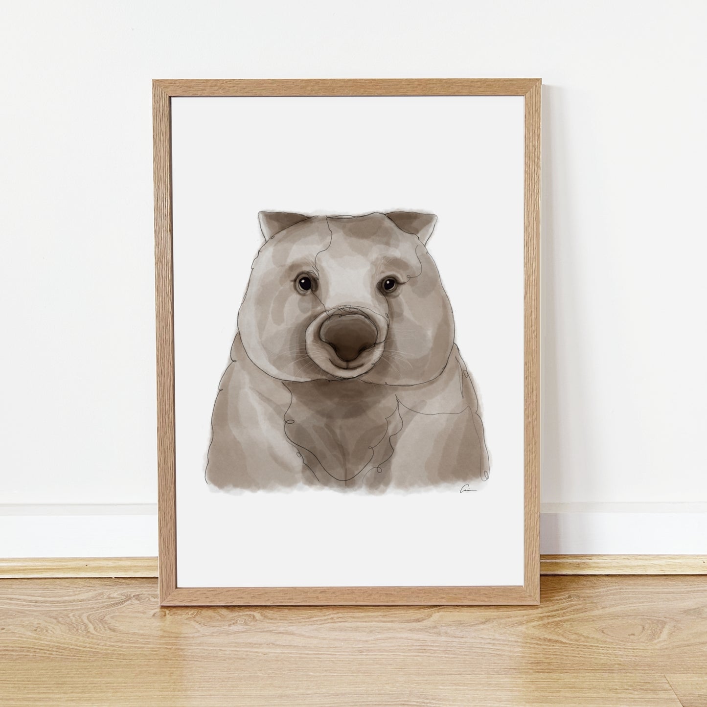 Framed artwork of a wombat face on a white background