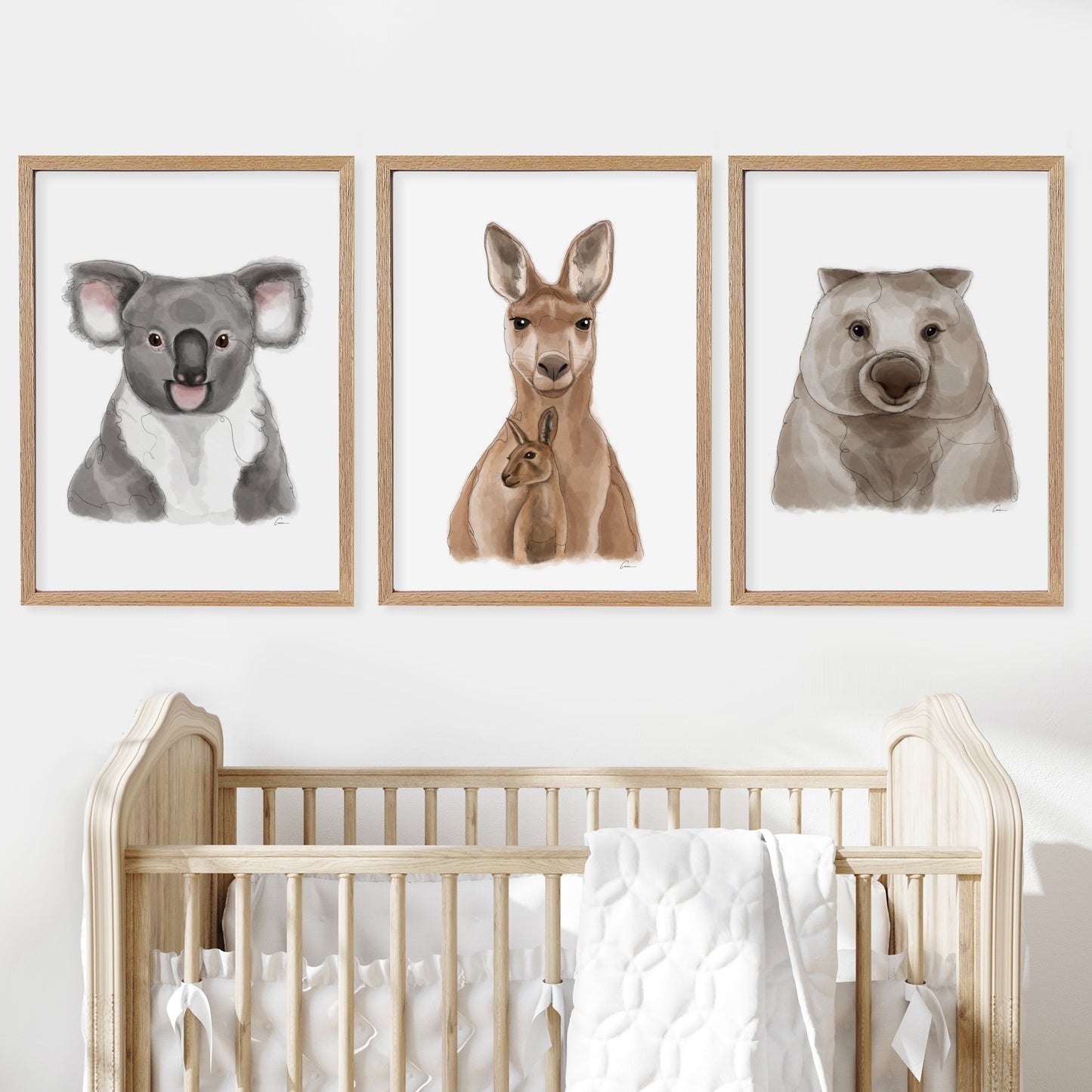 Nursery room with a wooden cot and wall art of a koala, kangaroo, and wombat.