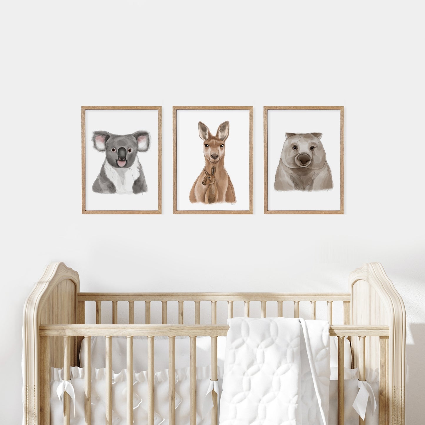 Nursery room with a wooden cot and wall art of a koala, kangaroo, and wombat.
