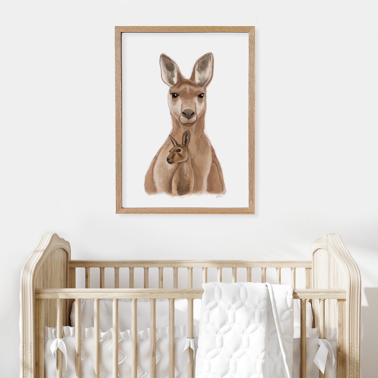 Framed illustration of a kangaroo on a wall above a cot in a baby nursery.