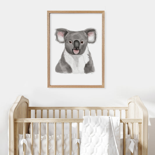 Framed illustration of a koala on a wall above a cot in a baby nursery.
