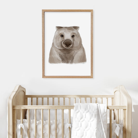 Framed illustration of a wombat on a wall above a cot in a baby nursery.