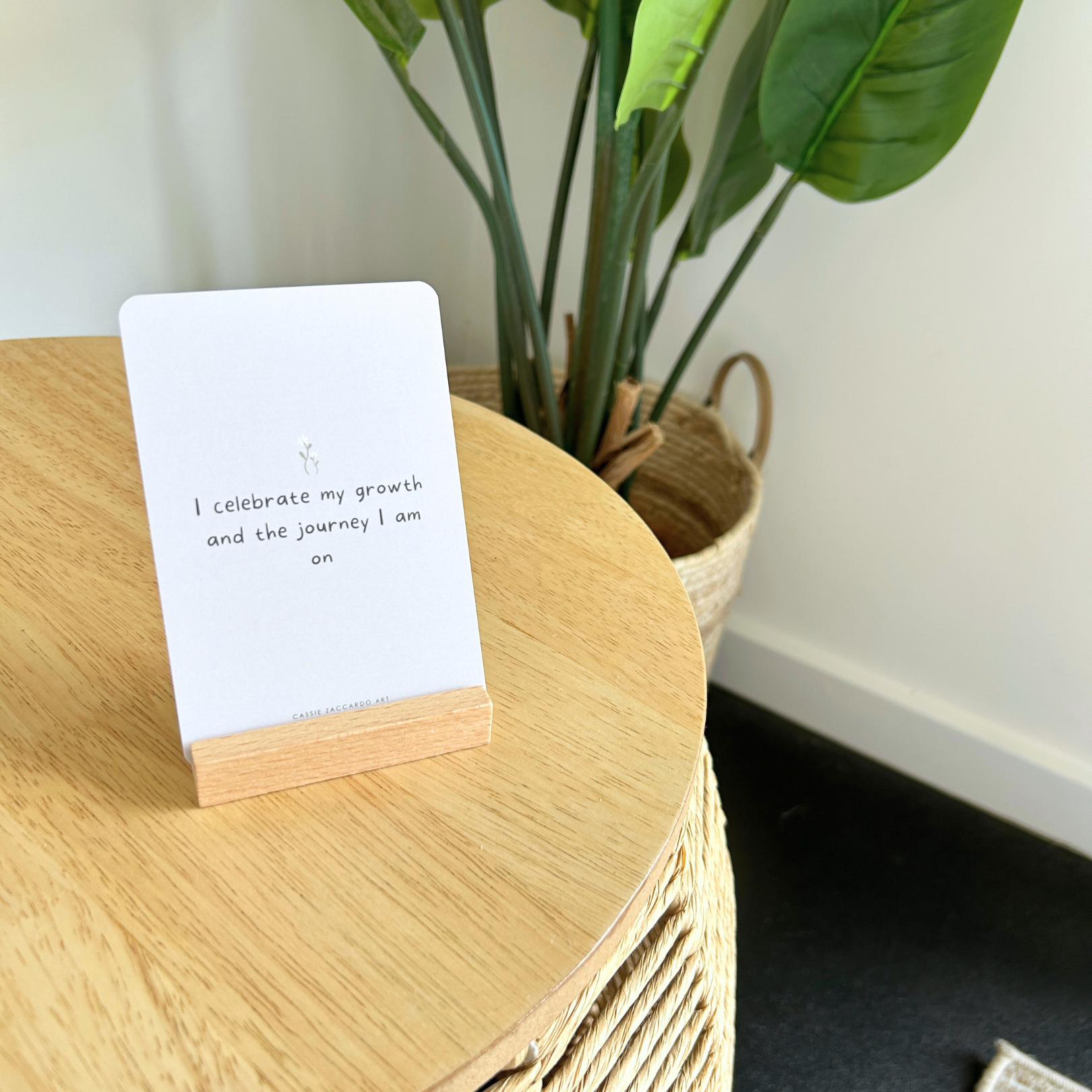 Daily affirmation card deck with wooden stand for self-care on nightstand