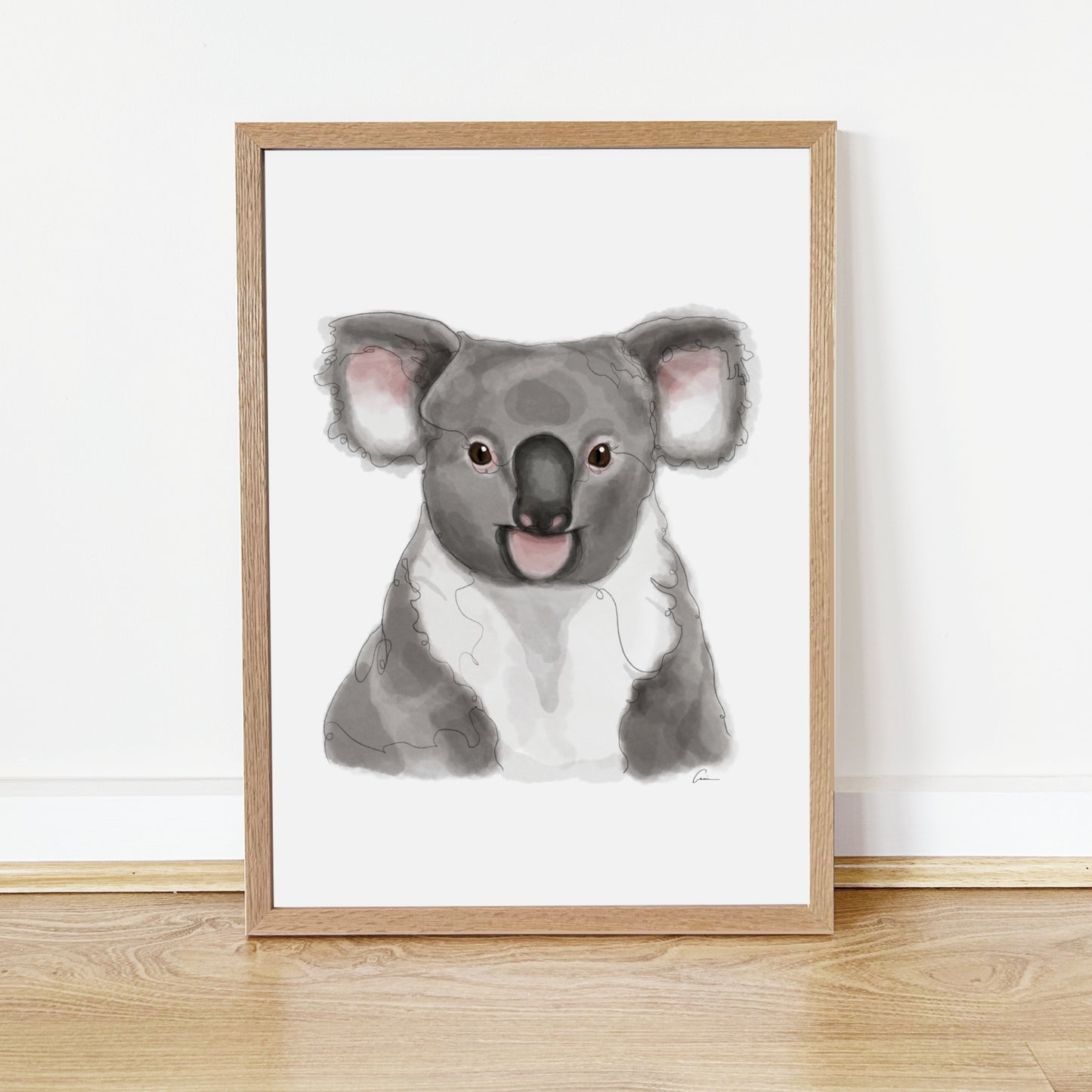 Framed artwork of a koala on a white wall.