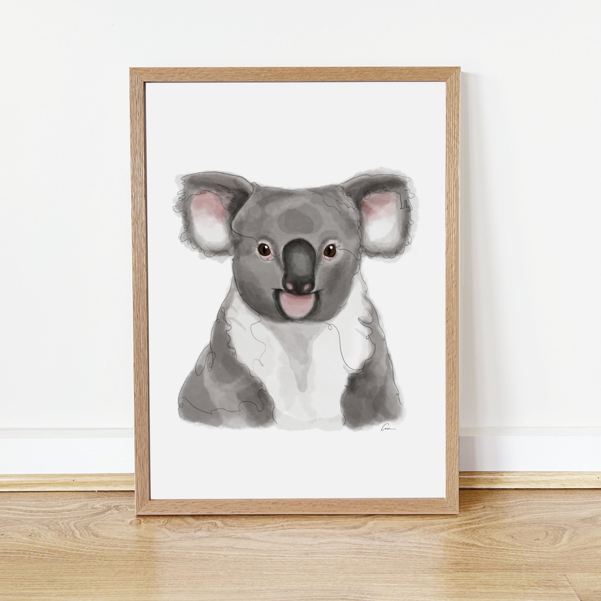 Framed artwork of a koala on a white wall.