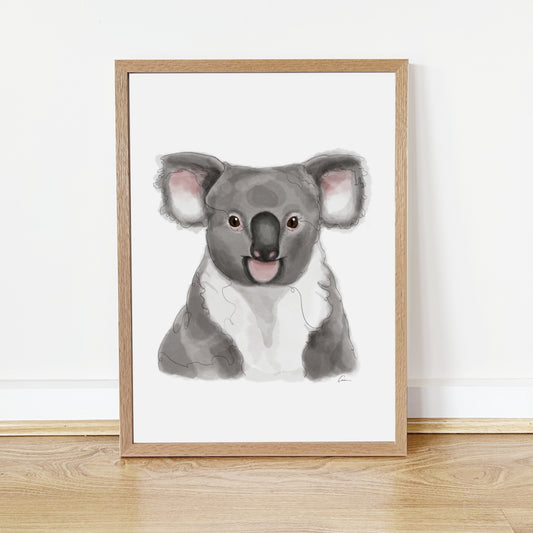 Framed artwork of a koala on a white wall.