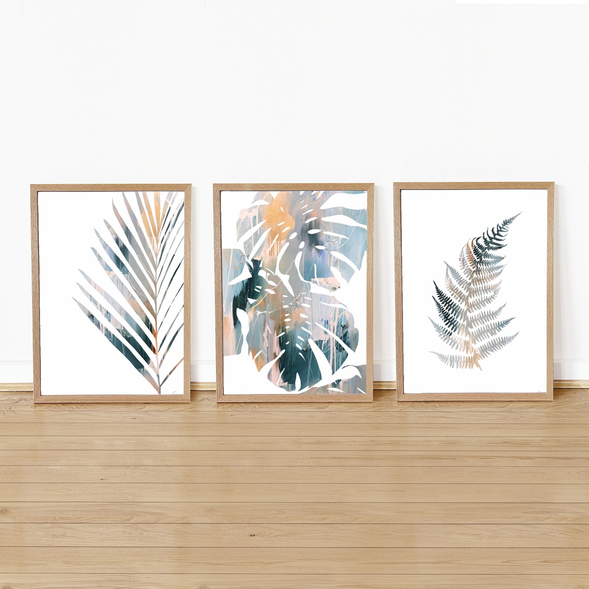 Three framed botanical prints on a wall with wooden flooring.
