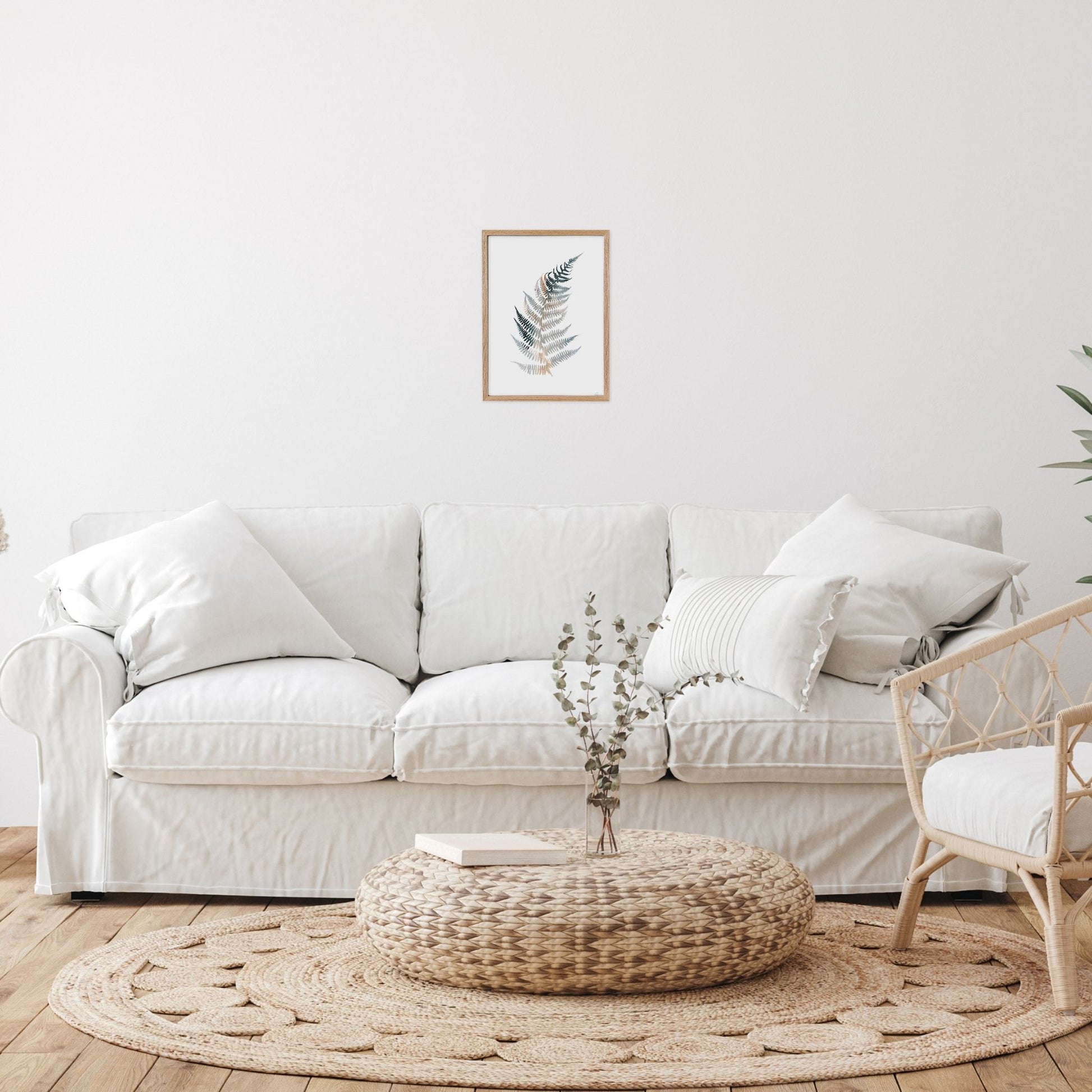 Living room with a white sofa, wicker chair, and decorative items.