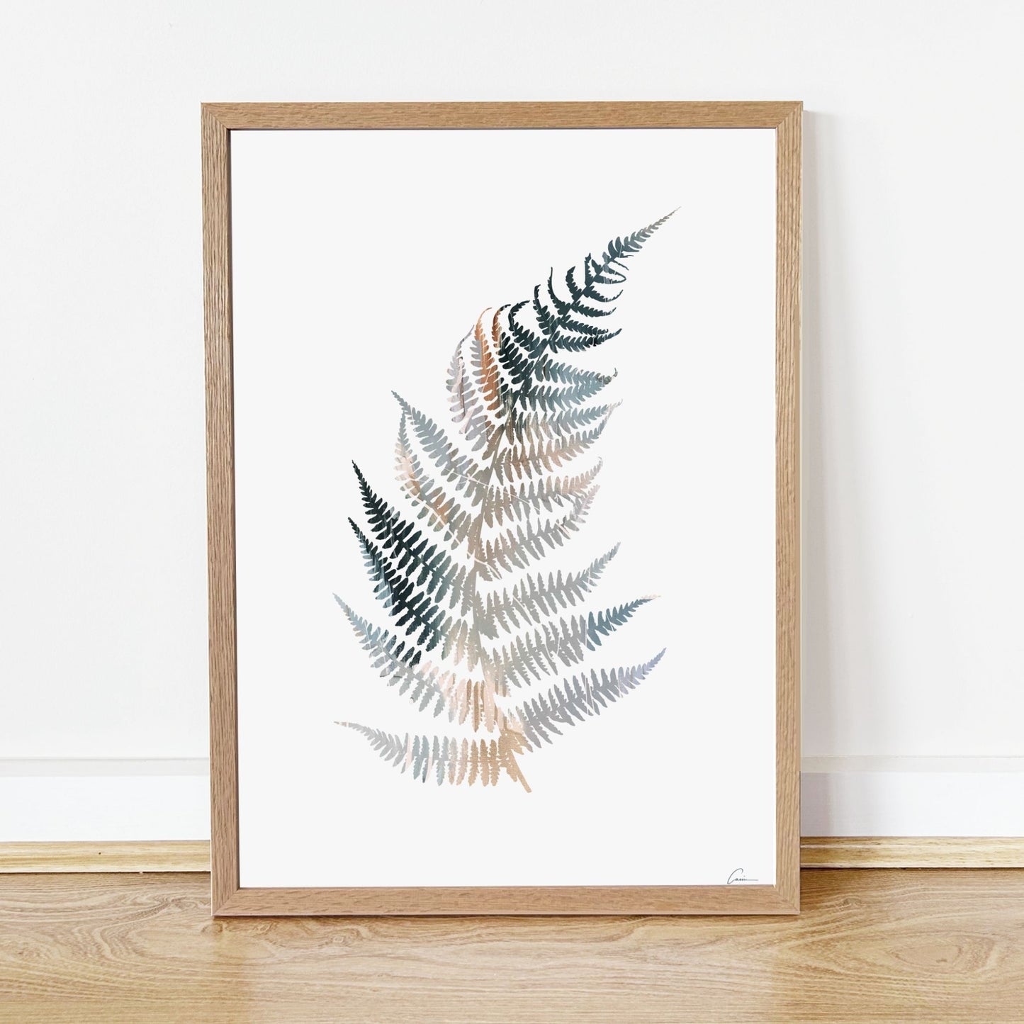 Framed artwork of a fern leaf design on a white background