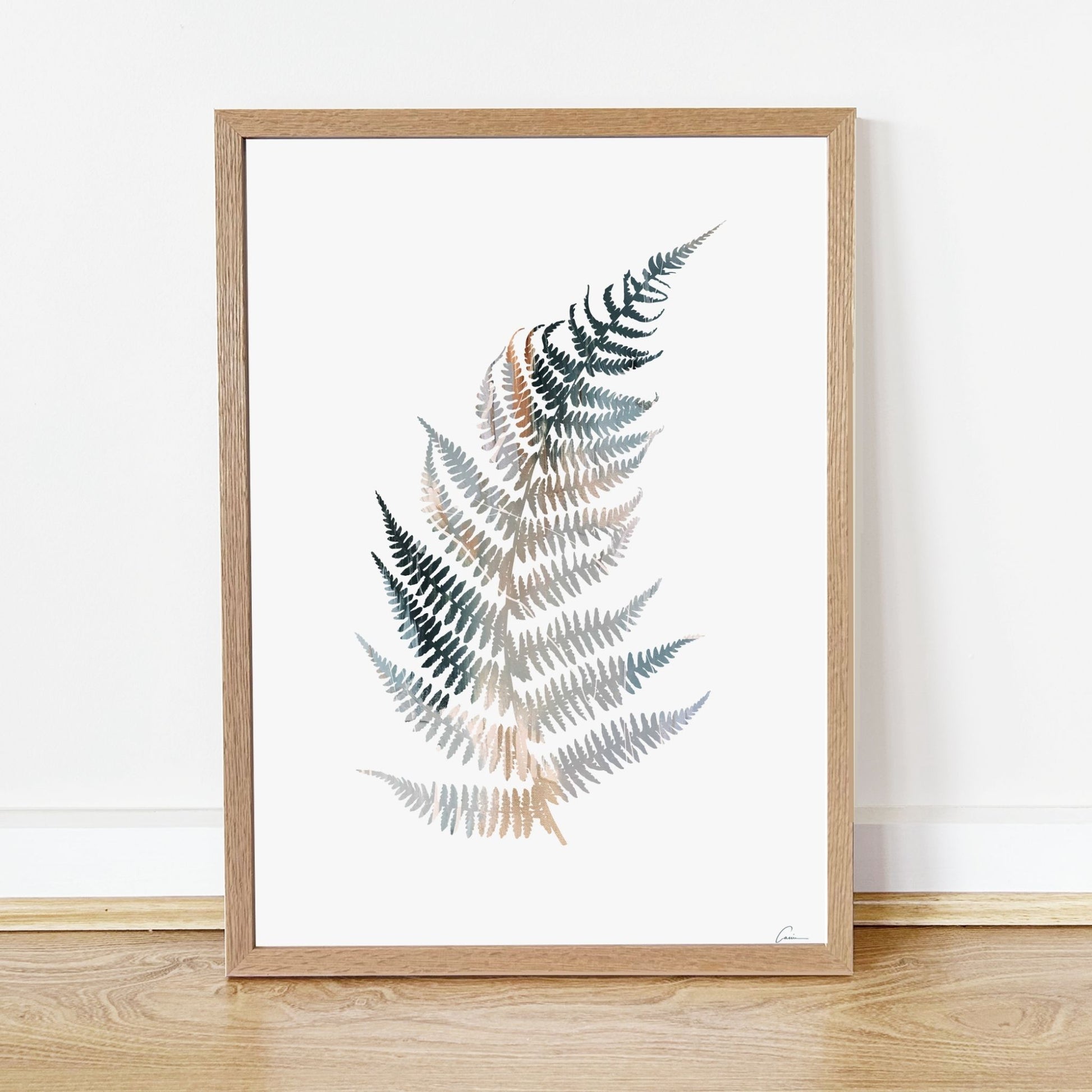 Framed artwork of a fern leaf design on a white background