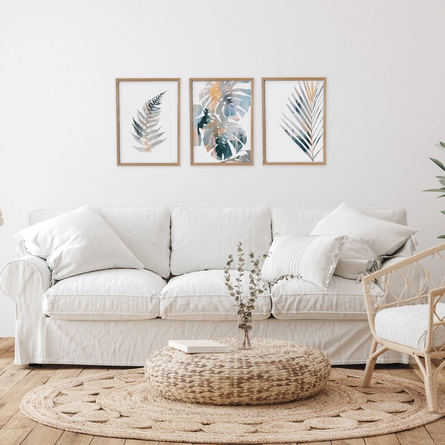 Living room with a white sofa, decorative pillows, and wall art.