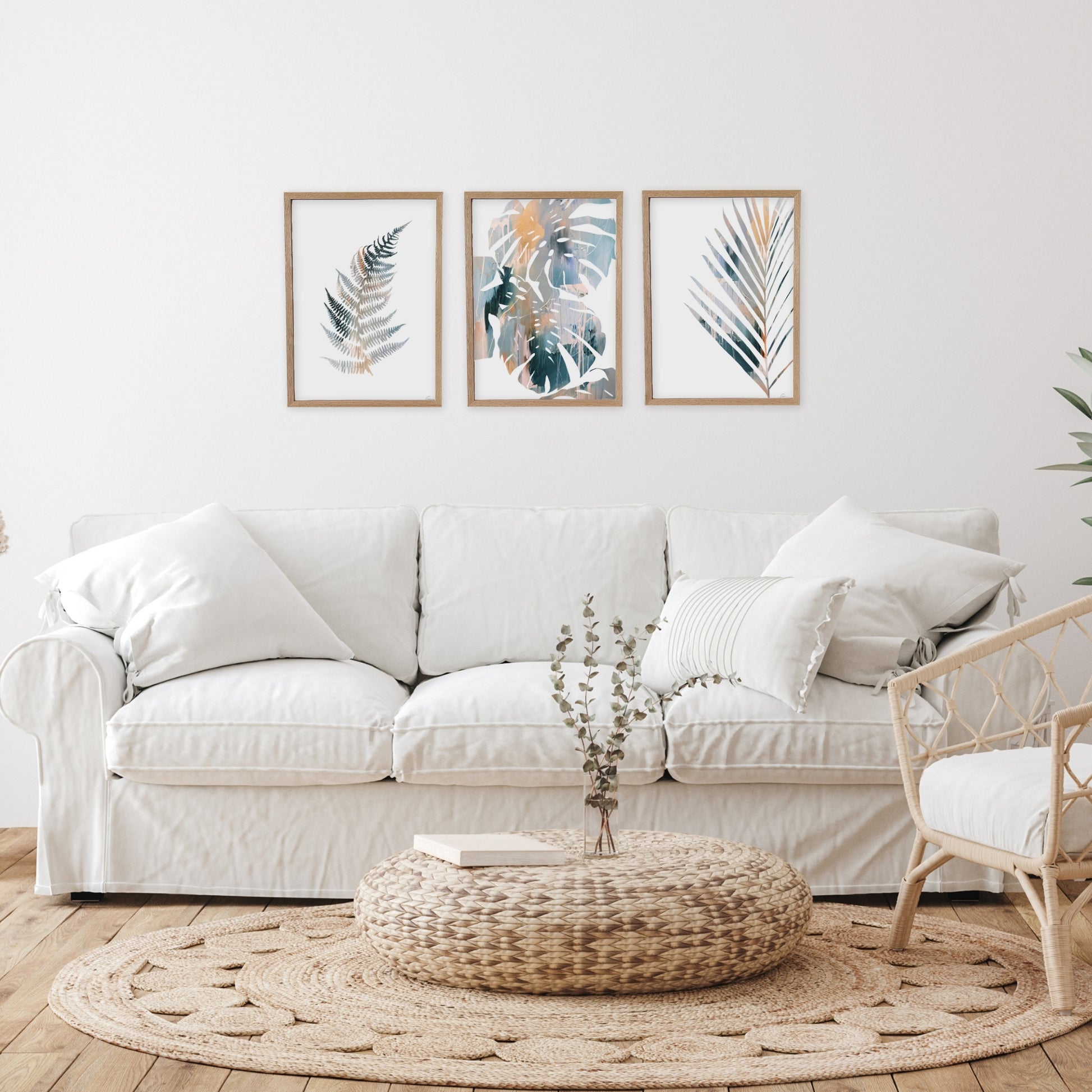 Living room with a white sofa, decorative pillows, and wall art.
