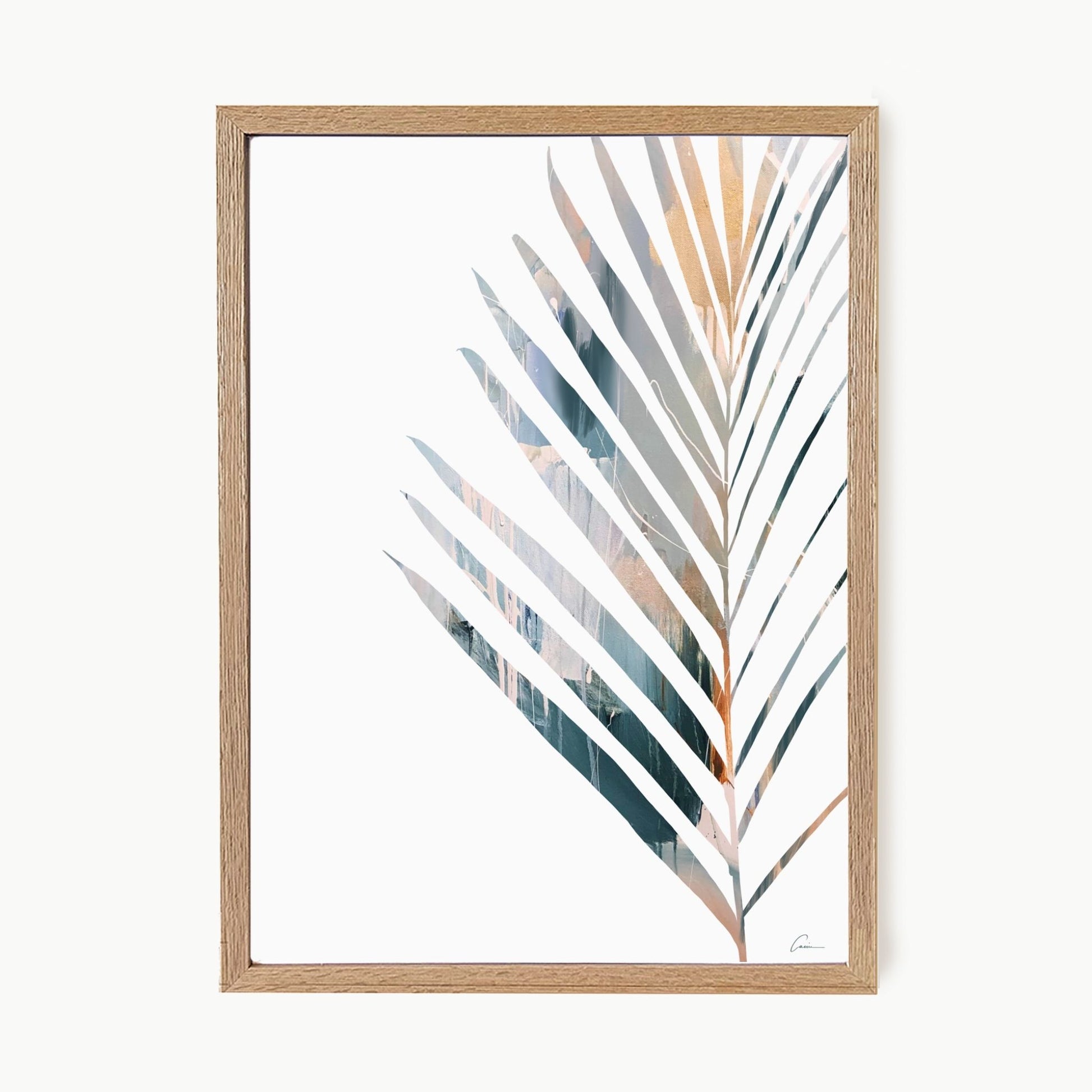 Framed artwork of a palm leaf with a wooden frame on a white background